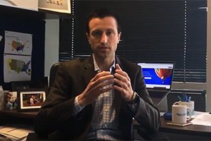Michael Rea, Founder & CEO, sits at his office desk