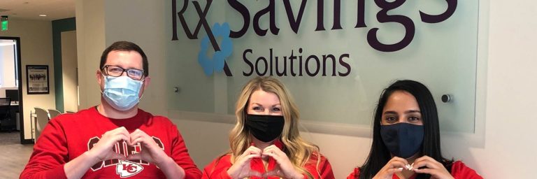 three employees making a heart symbol with their hands