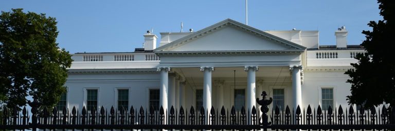 The White House photographed from behind the exterior fence