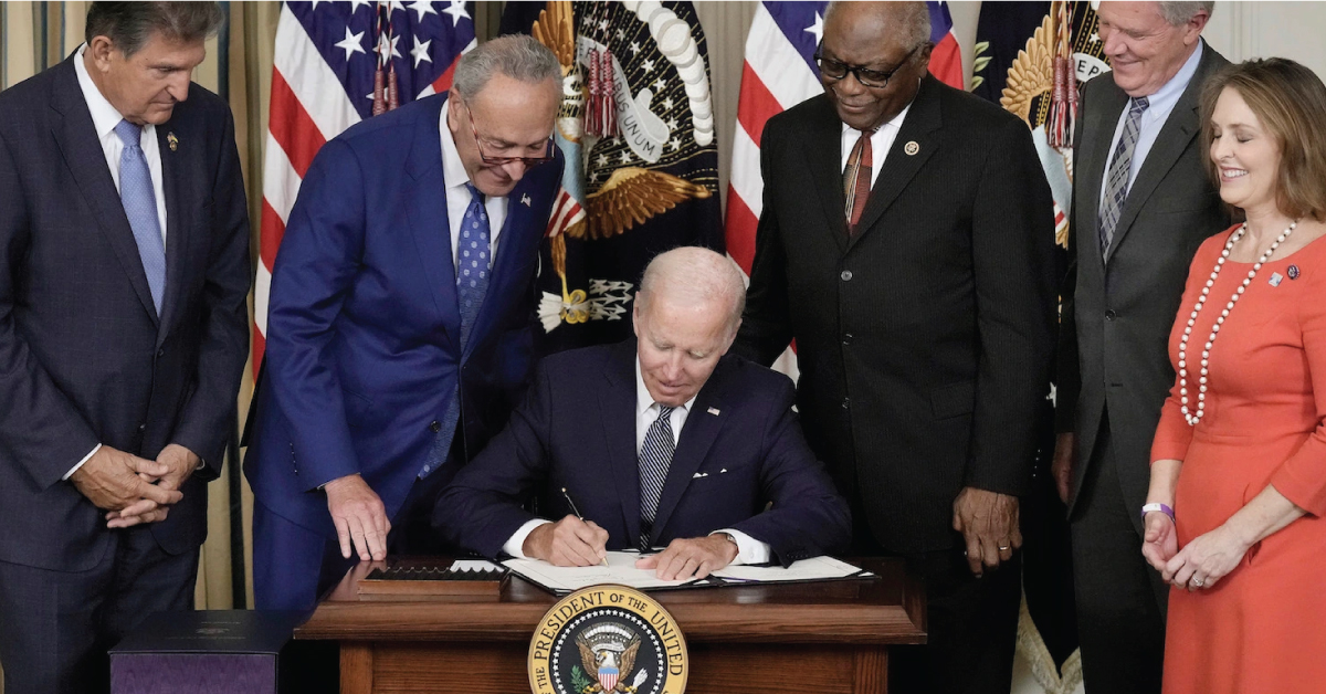 An image of President Biden signing the Inflation Reduction Act
