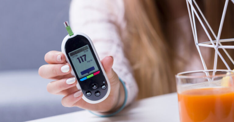 Close-up of blood sugar meter and healthy food for controlling diabetes