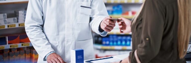 A customer paying at the pharmacy using a prescription discount card
