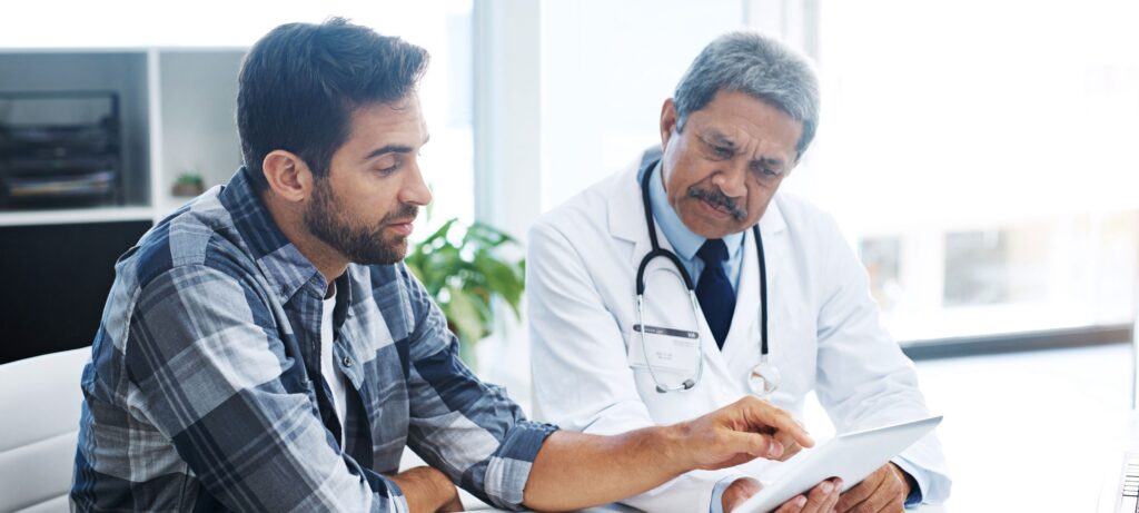 A man speaks with his doctor.
